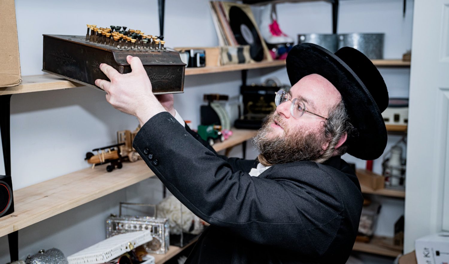 Jacob Rottenberg with an antique mechanical adding machine from the office collection